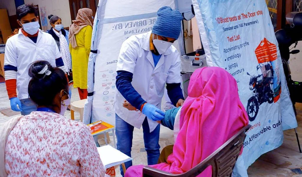 Healthcare workers caring for patients at a DrLaBike community camp